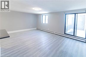 Niagara Falls apartment for rent - A spacious room with a sliding glass door and a window.