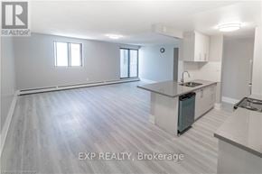 Niagara Falls (Downtown) apartment for rent - A realtor photo of a kitchen and living room with EXP REALTY, Brokerage watermark.