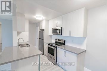 Niagara Falls (Downtown) apartment for rent - A kitchen with white cabinets and stainless steel appliances.