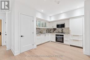 Toronto (Englemount-Lawrence) condo for rent - A kitchen with white cabinets and a marble backsplash.