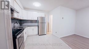 Toronto (South Parkdale) multi-family for rent - A small white bathroom with a toilet, sink, and shower.