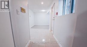 Toronto (South Parkdale) multi-family for rent - A room with wood flooring and a window with a white wall.