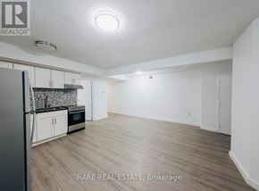 Toronto (South Parkdale) multi-family for rent - A room with wooden flooring and a window.