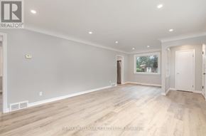 Whitby (Downtown Whitby) apartment for rent - A spacious room with wooden flooring and white walls.