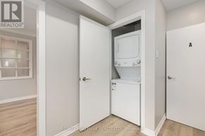 Whitby (Downtown Whitby) apartment for rent - A small white laundry room with a washer and dryer.
