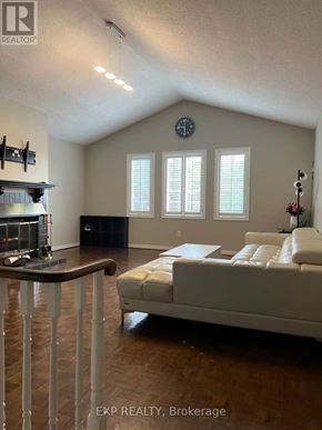 Pickering (Liverpool) apartment for rent - A living room with a couch, a fireplace, and a clock on the wall.