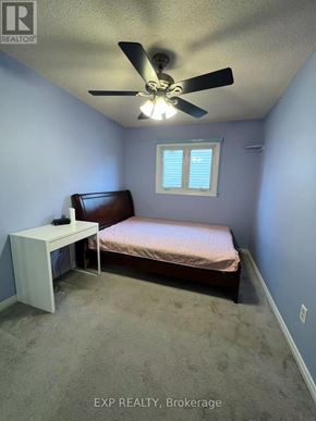 Pickering (Liverpool) apartment for rent - A bedroom with a bed, a fan, and a window.