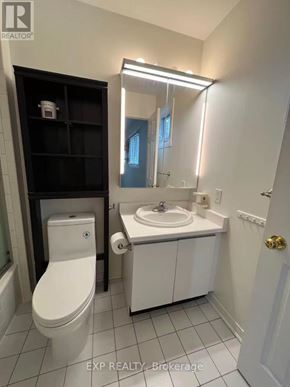 Pickering (Liverpool) apartment for rent - A white bathroom with a toilet, sink, and mirror.