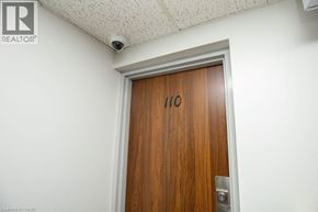 Kitchener condo for rent - A brown door with the number 110 on it.