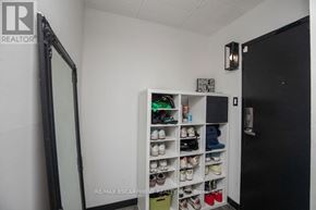 Kitchener condo for rent - A white shoe rack with multiple pairs of shoes on it.