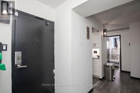 Kitchener condo for rent - A black door with a silver handle is on the left side of the image.