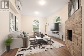 Oro-Medonte (Hawkestone) multi-family for rent - A living room with a stone fireplace and a flat screen TV.