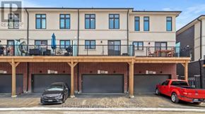 Oshawa (Eastdale) townhouse for rent - A modern two-story building with a balcony and a garage.