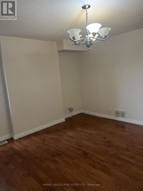 Toronto (Dovercourt-Wallace Emerson-Junction) apartment for rent - A room with wooden floors and a chandelier.