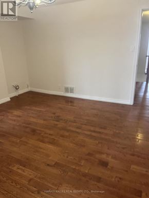 Toronto (Dovercourt-Wallace Emerson-Junction) apartment for rent - A room with wooden flooring and white walls.