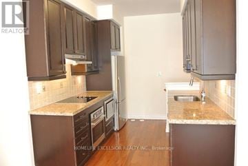 Toronto (Bridle Path-Sunnybrook-York Mills) townhouse for rent - A kitchen with brown cabinets and a marble countertop.