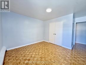 Toronto (Bendale) condo for rent - A room with a wooden floor and white walls.