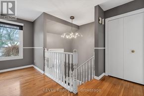 Niagara Falls (Oldfield) apartment for rent - A white staircase with a chandelier in a room with wooden floors.
