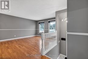 Niagara Falls (Oldfield) apartment for rent - A room with wooden flooring and a white railing.