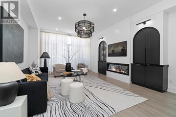 Toronto (Niagara) townhouse for rent - A modern living room with a fireplace and a large painting on the wall.
