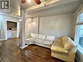 Windsor apartment for rent - A white couch sits in a room with wood floors and a ceiling fan.