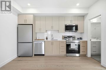 Ottawa multi-family for rent - A modern kitchen with a stainless steel sink and appliances.
