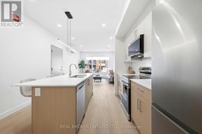 Ottawa multi-family for rent - A spacious room with a large window and a door leading to another room.