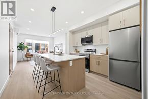 Ottawa multi-family for rent - A white door is open to reveal a black washing machine.