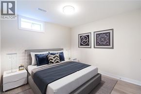 Hamilton apartment for rent - A bedroom with a large bed and two pictures on the wall.