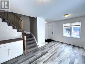 Ottawa townhouse for rent - A room with a staircase and a window.