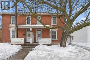 Guelph apartment for rent - A red brick house with a white door and windows.
