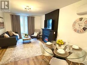 London East (East F) multi-family for rent - A living room with a couch, chairs, a coffee table, and a fireplace.