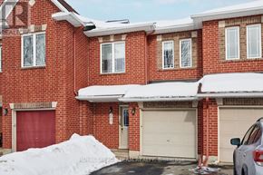 Ottawa townhouse for rent - A red brick house with a white garage door and a white car parked in front.