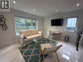 Vancouver apartment for rent - A living room with a couch, a chair, and a television.
