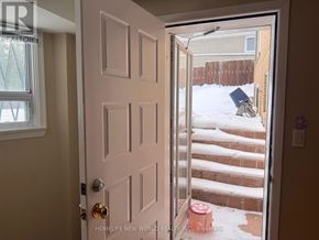 Toronto (Bayview Village) apartment for rent - A door with a glass window is open and a snowy staircase is visible outside.