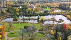 Whitchurch-Stouffville apartment for rent - A brochure for RE/MAX Imperial Realty Inc. shows a beautiful aerial view of a lake surrounded by trees in autumn colors.