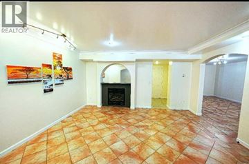 North Vancouver apartment for rent - A living room with a fireplace and a tile floor.