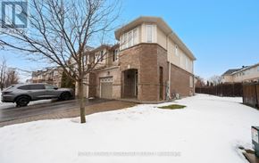 Oakville (Bc Bronte Creek) townhouse for rent - A grey car is parked on a snowy street in front of a brick building.