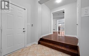 Oakville (Bc Bronte Creek) townhouse for rent - A white door with a Royal LePage Signature Realty Brokerade sign on it.