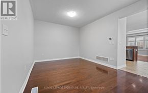 Oakville (Bc Bronte Creek) townhouse for rent - A room with wooden flooring and white walls, with a Royal LePage Signature Realty logo in the corner.