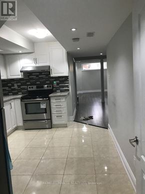 Mississauga (Churchill Meadows) apartment for rent - A kitchen with tile flooring and a stone backsplash.