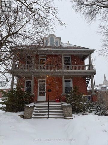 Carleton Place apartment for rent - A red brick house with a balcony and a small tower on the roof.