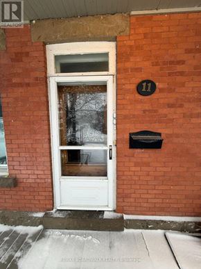 Carleton Place apartment for rent - A white door with a black mailbox on a red brick wall.