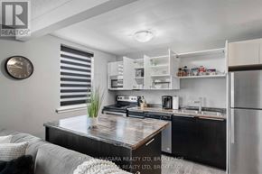 Niagara Falls (Downtown) multi-family for rent - A modern kitchen with a wooden island and stainless steel appliances.