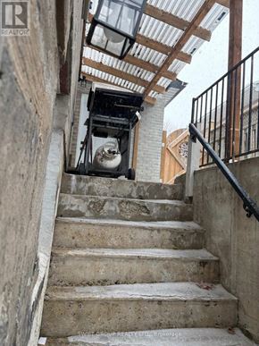 Whitby (Downtown Whitby) apartment for rent - A staircase with a metal railing and a concrete wall.