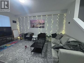 Ottawa townhouse for rent - A living room with a black coffee table and a grey couch.