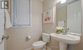 Brampton (Fletcher's West) apartment for rent - A white toilet sits next to a white sink in a bathroom.