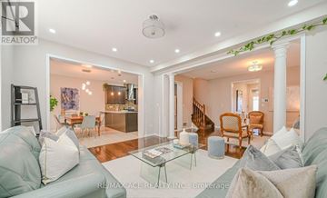 Brampton (Fletcher's West) apartment for rent - A living room with a grey couch and a glass coffee table.