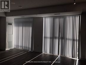 Vaughan (Vaughan Corporate Centre) condo for rent - A room with a sliding door and wooden flooring.