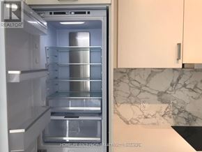 Vaughan (Vaughan Corporate Centre) condo for rent - A refrigerator with the door open showing the empty shelves.